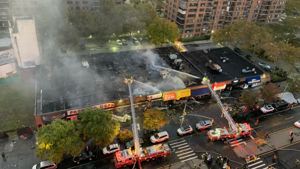 FDNY crews operating multiple aerial devices during a five-alarm commercial fire in Harlem on Wednesday, Nov. 3, 2021.