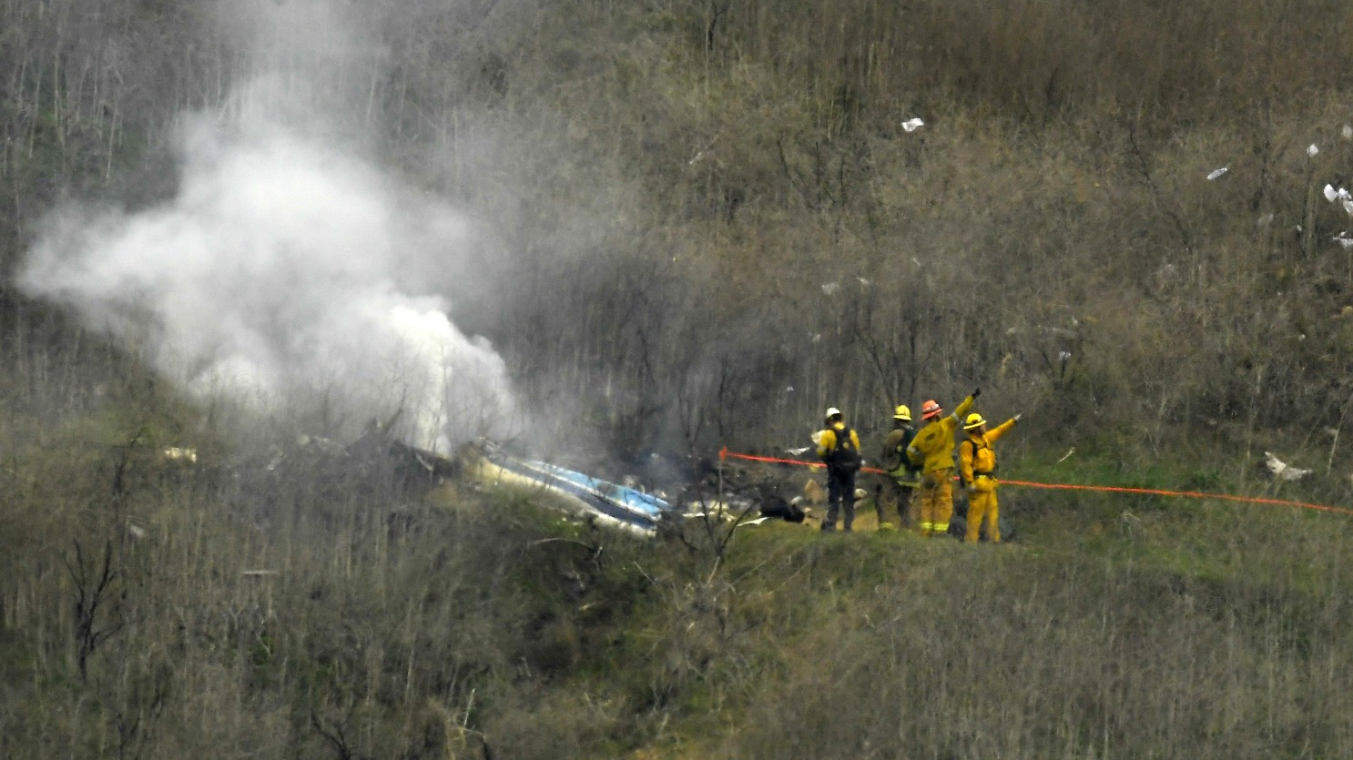 Firefighters operate at the scene of a helicopter crash that took the lives of nine people in January 2020.