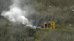Firefighters operate at the scene of a helicopter crash that took the lives of nine people in January 2020.
