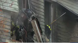 Firefighters perform overhaul at a dwelling fire with hoarding conditions in Manchester, NH, on Monday, Nov. 15, 2021.