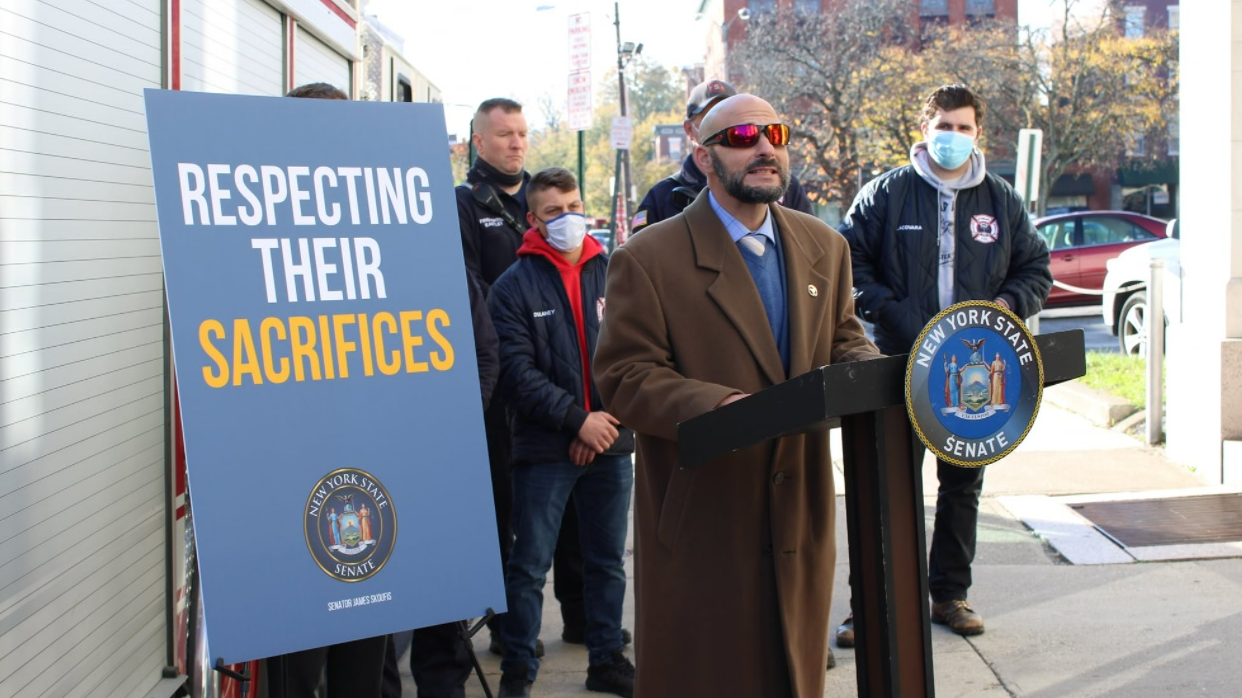 A Stewart Air National Guard Base firefighter speaks at a press conference announcing passage of a law granting disability benefits to state-employed firefighters.