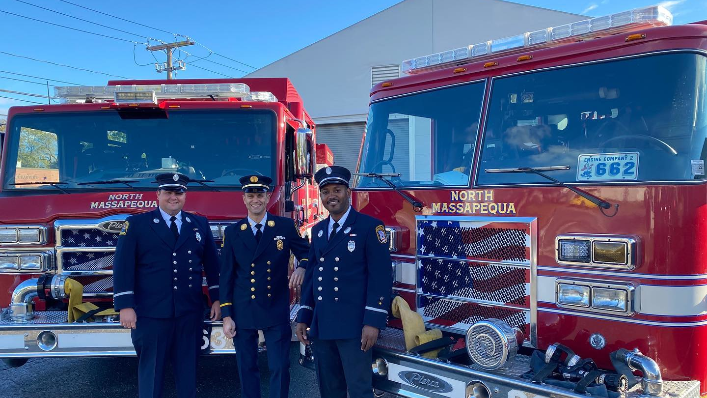 North Massapequa Fire Deartment members stand in front of their two refurbished Pierce engines.