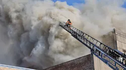 Firefighters battle a major structure fire that damaged businesses and apartments in Oak Park, IL, on Nov. 23, 2021.