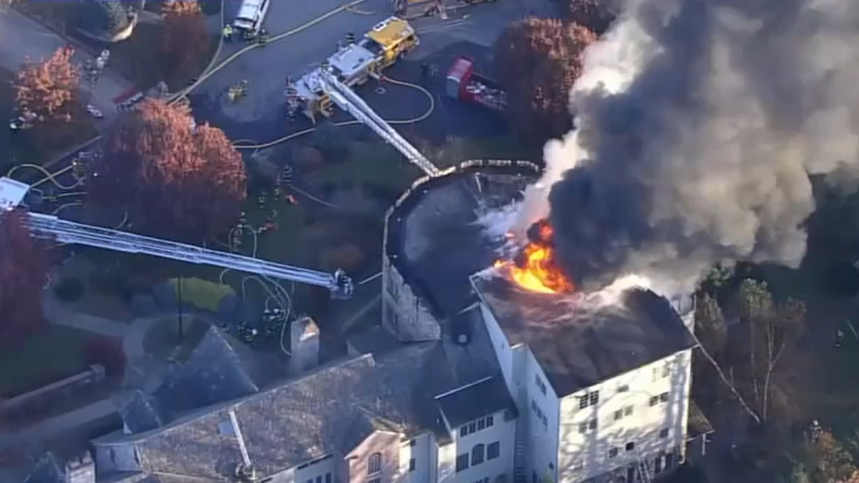 Firefighters use multiple aerials to battle a well involved fire at an estate in Lehigh County, PA, on Tuesday, Nov. 16, 2021.