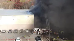 Firefighters use a ladder truck to control the fire during operations at a furniture manufacturer in Rush Township, PA. Firefighters use a ladder truck to control the fire during operations at a furniture manufacturer in Rush Township, PA.