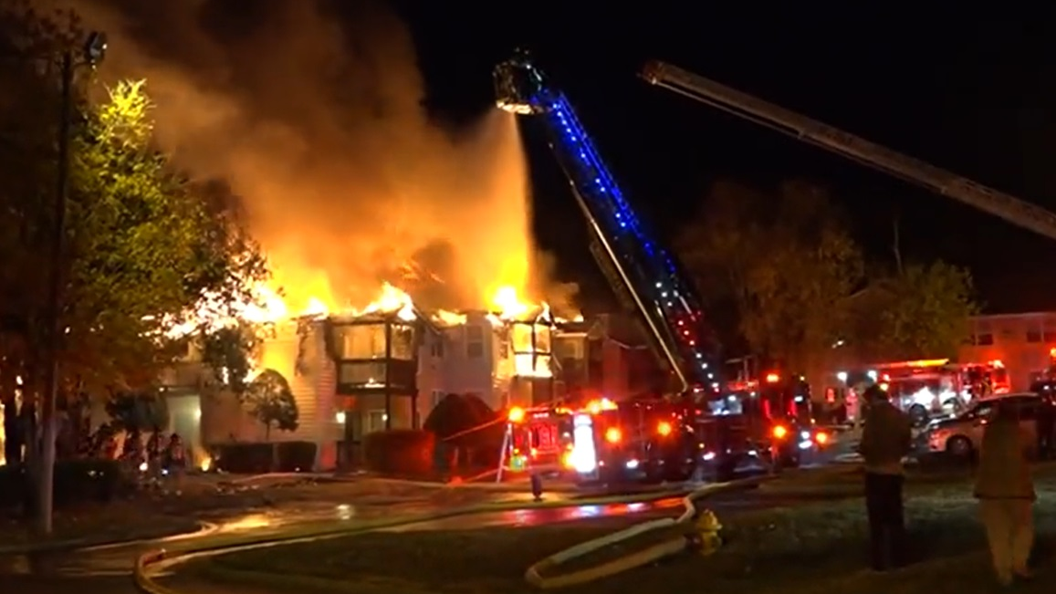 Firefighters use aerial devices to control a Pineville, NC, apartment building fire on Monday, Nov. 15, 2021.