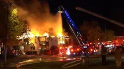 Firefighters use aerial devices to control a Pineville, NC, apartment building fire on Monday, Nov. 15, 2021.