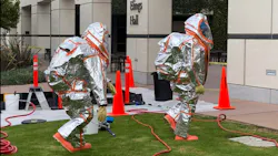 Hazardous Materials team members prepare to make entry to monitor for leaks at a building on the campus of UC Santa Barbara in Isla Vista, CA.