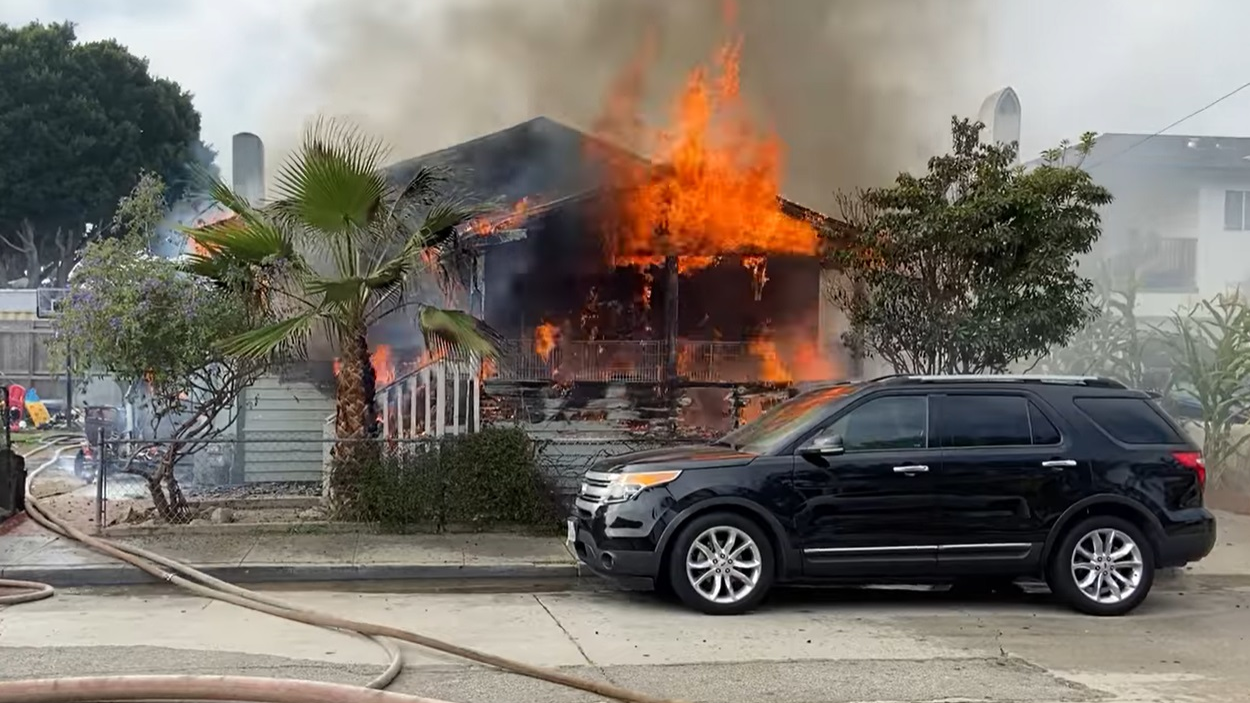 Firefighters stretch lines to attack a well involved structure in Santa Barbara, CA, on Wednesday, Nov. 17, 2021.