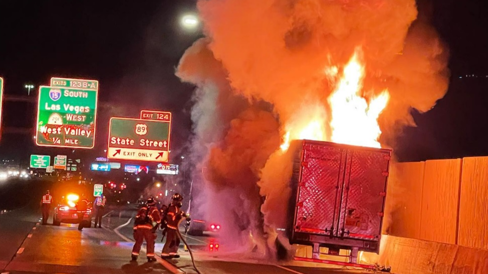 Firefighters work to extinguish a semi fire on Interstate 80 in Salt Lake City on Thursday, Nov. 11, 2021.