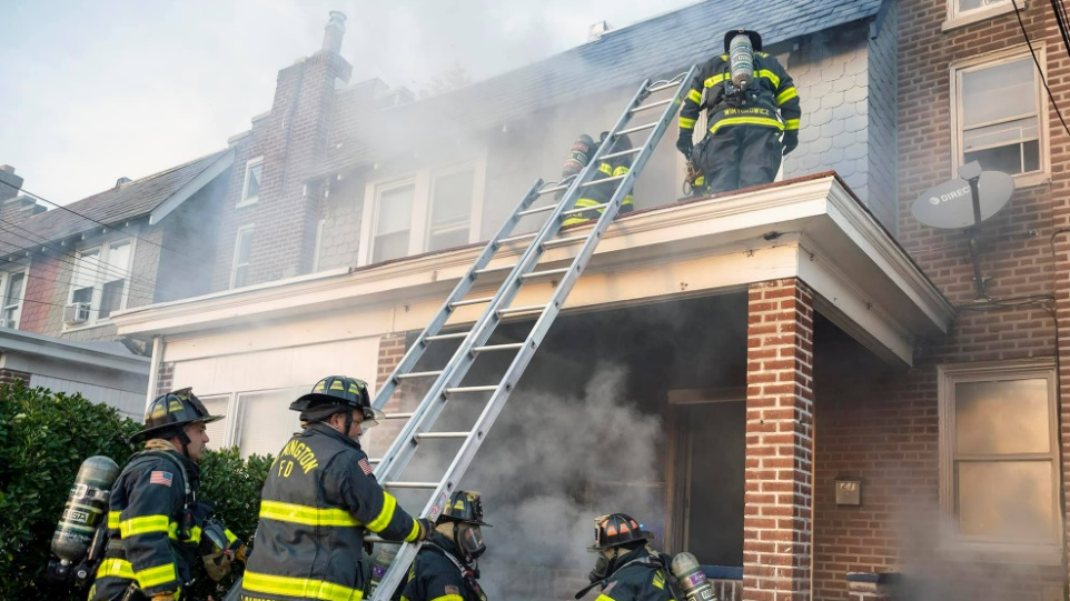 Firefighters working to control a basement fire in Wilmington