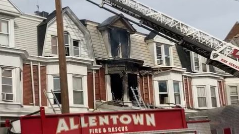 A fire at a three-story residence smolders in Allentown, PA, on Thursday, Nov. 11, 2021.