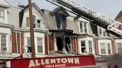 A fire at a three-story residence smolders in Allentown, PA, on Thursday, Nov. 11, 2021.