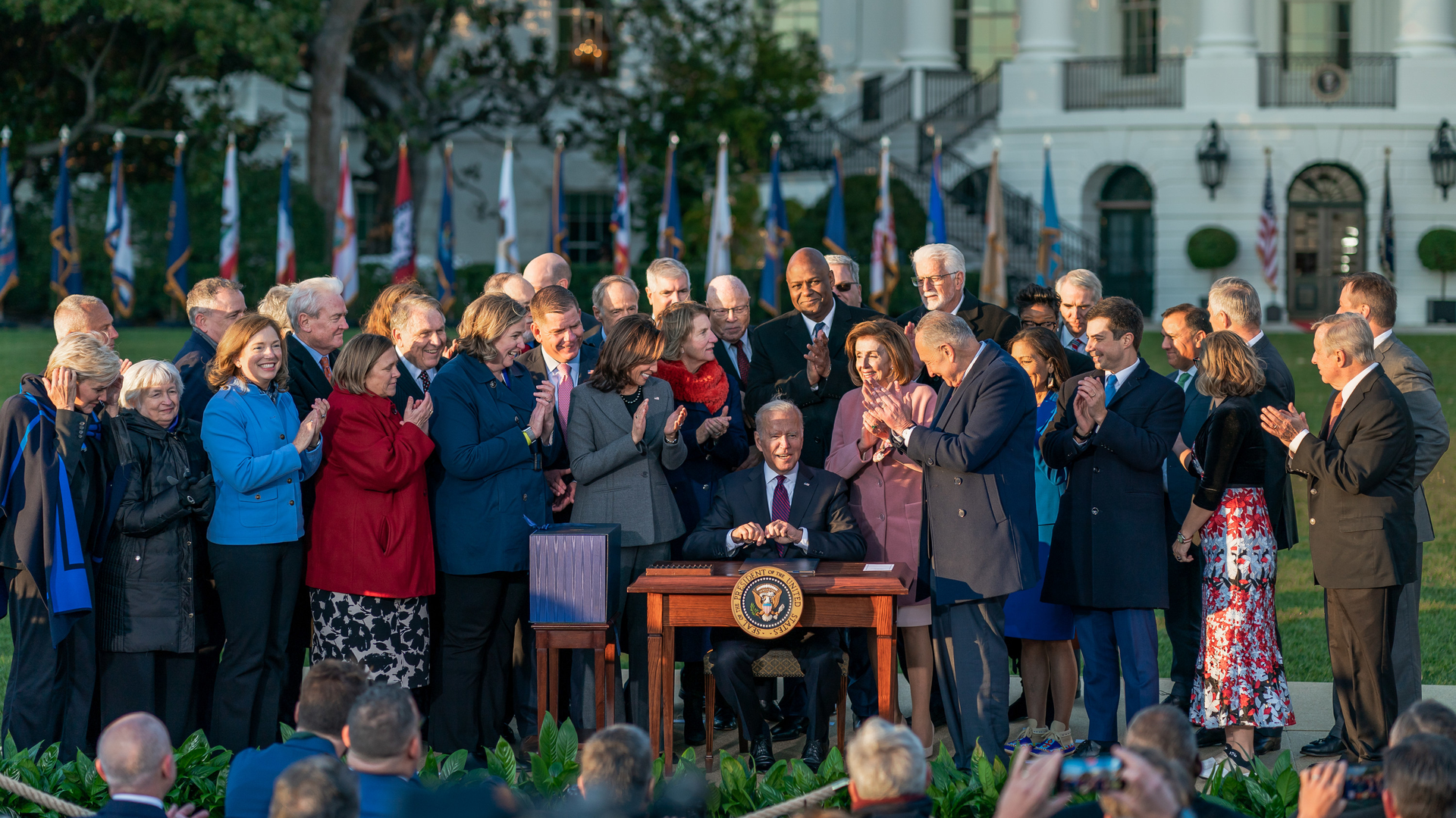 President Joe Biden and lawmakers on the South Lawn of the White House as he signs legislation into law that will benefit the fire and emergency services.