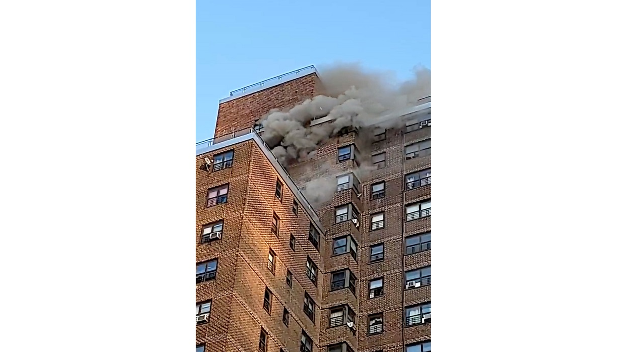 Smoke pours from the upper floors of a Bronx apartment building during a fire that killed a six-year-old boy on Friday, Nov. 5, 2021.