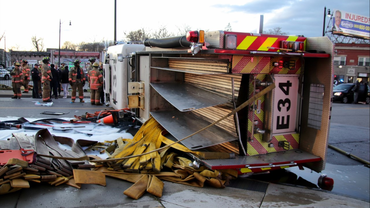 The Buffalo, NY, Fire Department's Engine 34 sits on its side after overturning while swerving to avoid hitting another vehicle during a response call on Friday, Nov. 19, 2021.