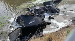 The shell of a burned-out semi-truck sits in a canal in Boynton Beach, FL, after crashing and catching fire on Wednesday, Nov. 17, 2021.