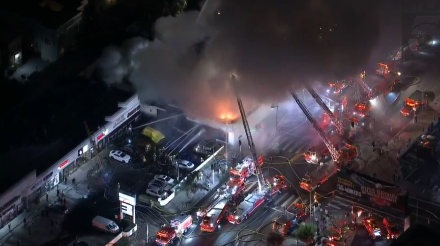 Firefighters battle a fire at a strip mall in the Koreatown section of Los Angeles on Thursday, Nov. 4, 2021.