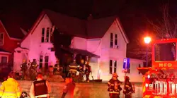 Firefighters on scene after dousing a duplex fire that critically injured a man in Minneapolis on Monday, Nov. 8, 2021.