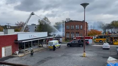 Firefighters battle an arson fire that leveled a laundromat in Palmyra, NY, on Wednesday, Nov. 3, 2021.