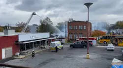 Firefighters battle an arson fire that leveled a laundromat in Palmyra, NY, on Wednesday, Nov. 3, 2021.