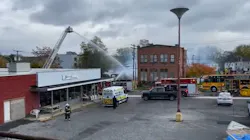 Firefighters battle an arson fire that leveled a laundromat in Palmyra, NY, on Wednesday, Nov. 3, 2021.
