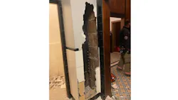 Firefighters used a sledgehammer to break through a wall after a man who was hiding in a theater for days became trapped behind it on Friday, Nov. 5, 2021.