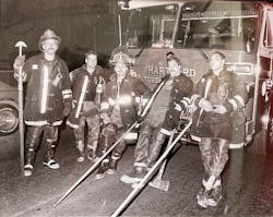 Leigh Shapiro, far left, holds a Hartford hook - used for tearing through walls and ceilings - in a photo from the 1980s that hangs on a wall in Hartford's South Green fire station, Engine Company 1 Ladder 6. Leigh Shapiro, far left, holds a Hartford hook - used for tearing through walls and ceilings - in a photo from the 1980s that hangs on a wall in Hartford's South Green fire station, Engine Company 1 Ladder 6.