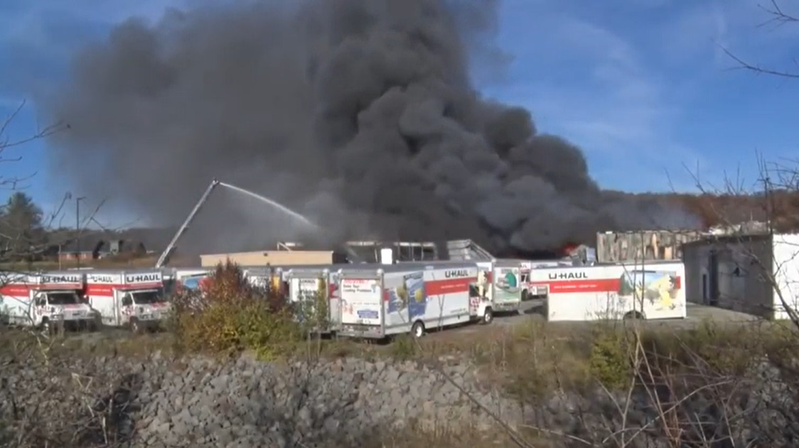 Firefighters use an aerial ladder to control a commercial fire in Beckley, WV, on Wednesday, Nov. 17, 2021.