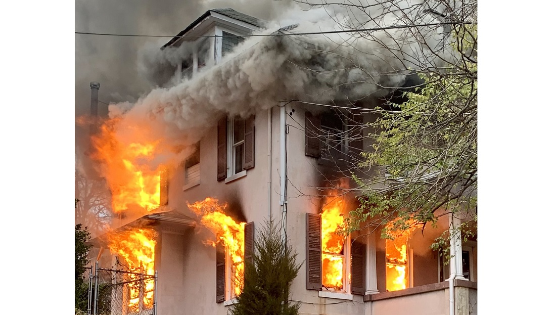 D.C. Firefighters arrive to a house with heavy fire showing on multiple floors.
