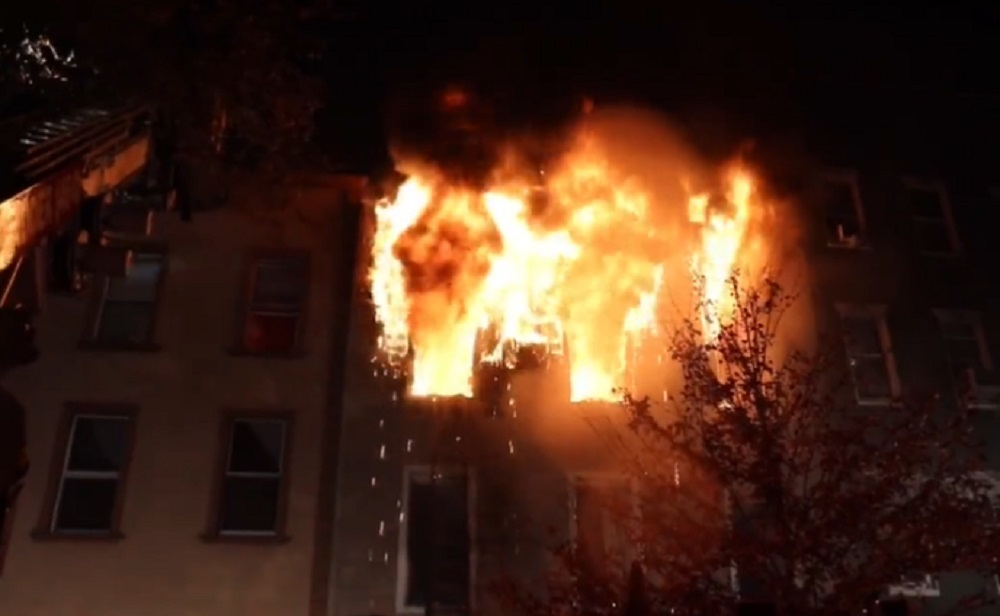 Heavy fire showing from a Brooklyn 3-story apartment that left a dozen homeless on Nov. 25, 2021