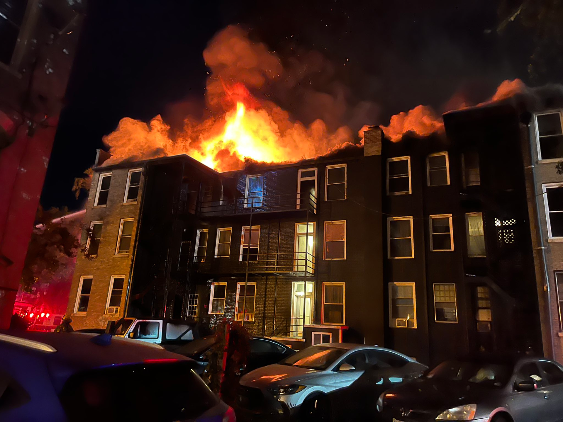 Fire advances through the roof of a 15 unit apartment in Norfolk where firefighters made 6 rescues.