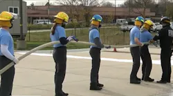 High school students train with Overland Park firefighters earning fire service certifications.