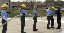 High school students train with Overland Park firefighters earning fire service certifications. High school students train with Overland Park firefighters earning fire service certifications.