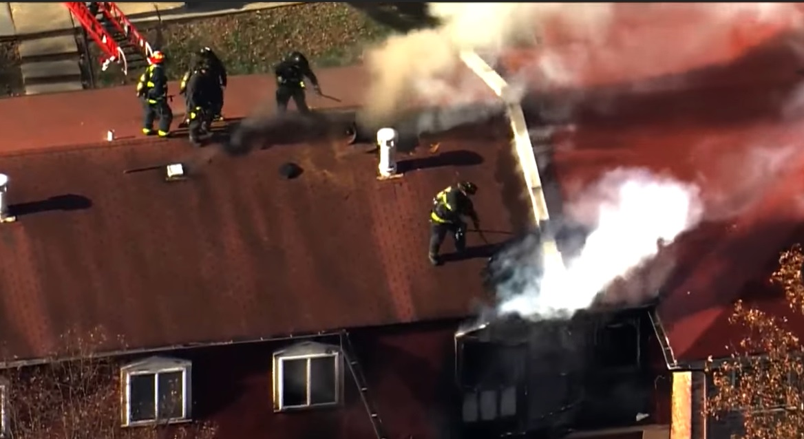 Saint Louis firefighters open up the roof during an apartment fire.