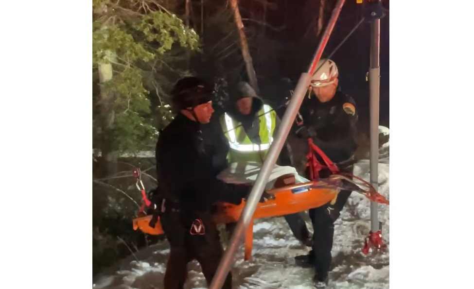 Firefighters bring a motorist to safety after being located by a DOT plow driver on Nov. 23, 2021.