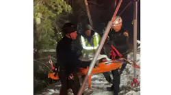 Firefighters bring a motorist to safety after being located by a DOT plow driver on Nov. 23, 2021.