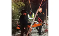Firefighters bring a motorist to safety after being located by a DOT plow driver on Nov. 23, 2021.