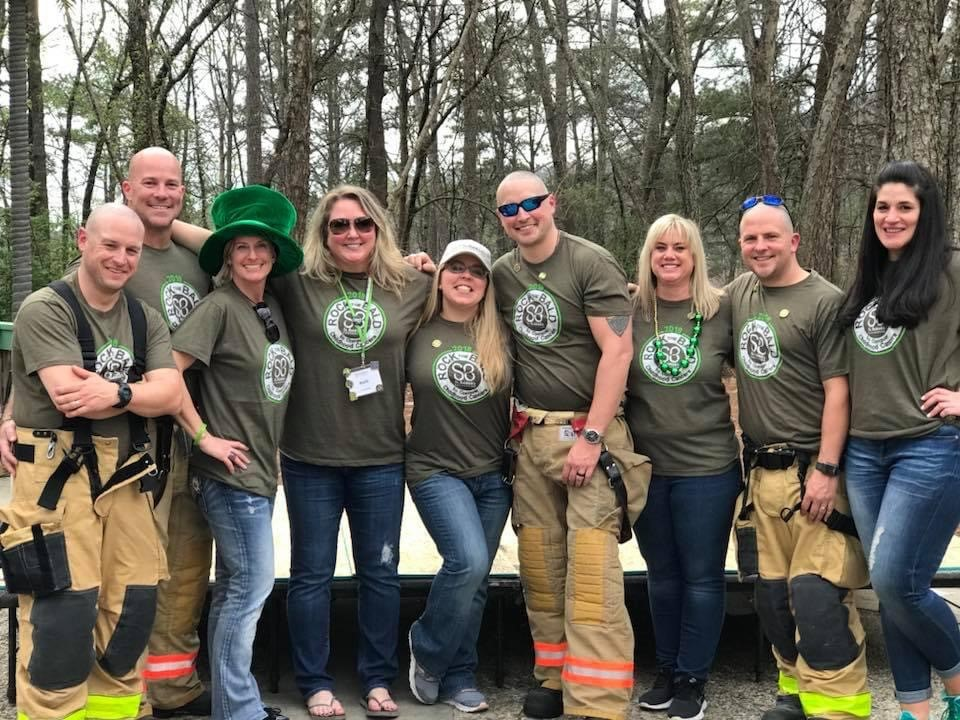 Brad Blakeney (second from left) co-hosts an annual head-shaving even to raise money to help to prevent childhood cancer.