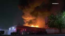 Fire breaks through the roof during a commercial building fire in Baldwin Park.