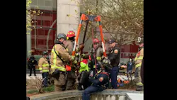 Atlanta firefighters rescue a worker who fell at the Coca-Cola headquarters.