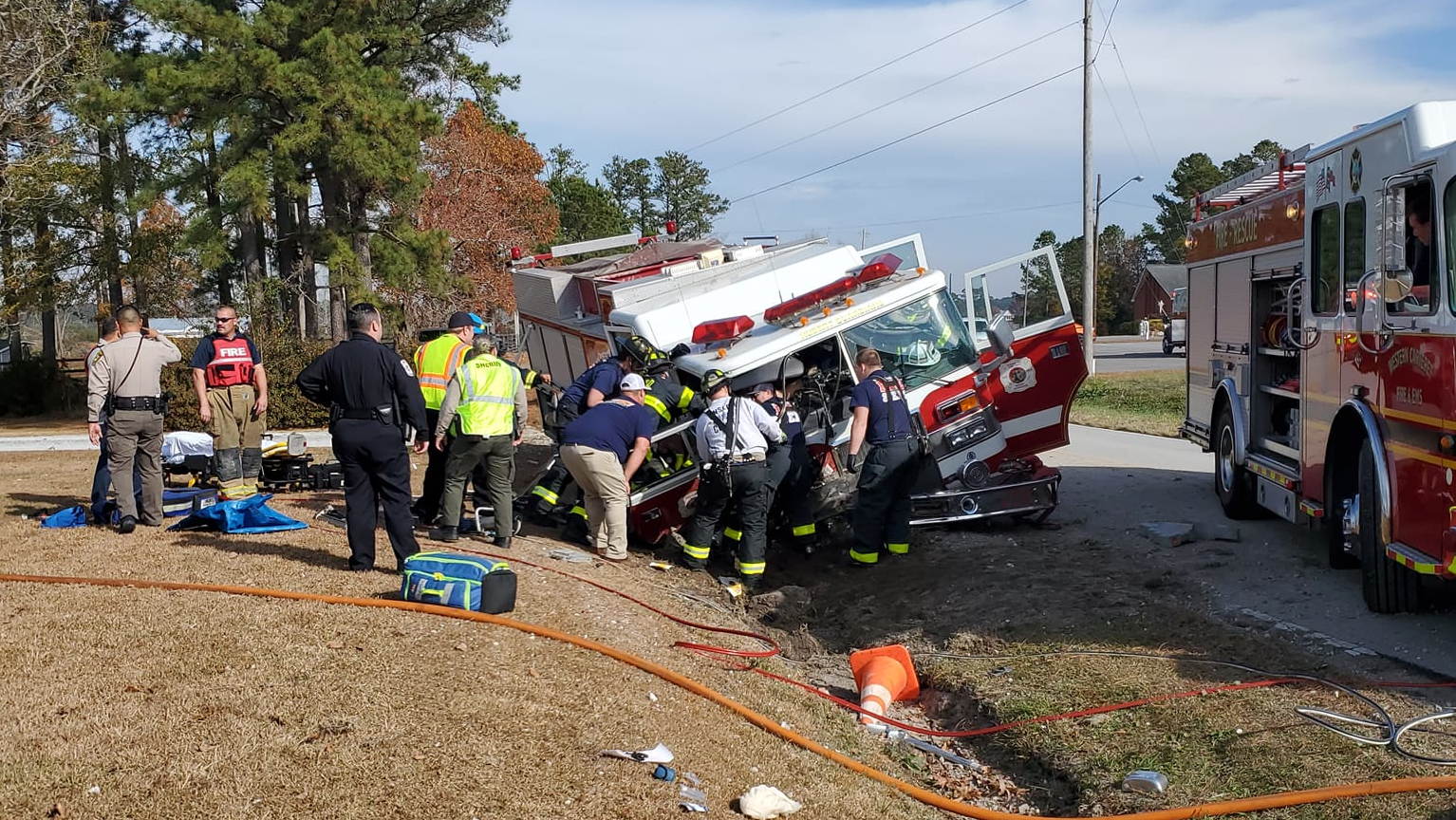 Fire and EMS crews tend to the injured Hubert firefighters at the crash scene Saturday.