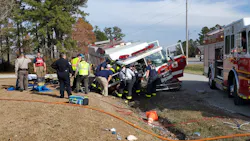 Fire and EMS crews tend to the injured Hubert firefighters at the crash scene Saturday.