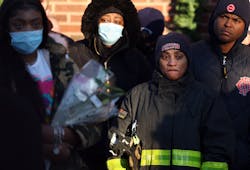Firefighters and family members gather during a prayer vigil for Chicago firefighter Mashawn Plummer and resident Eladio Luis Gomez. Firefighters and family members gather during a prayer vigil for Chicago firefighter Mashawn Plummer and resident Eladio Luis Gomez.