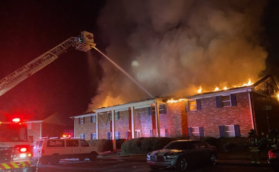 Firefighters use an aerial tower to control fire in an Augusta apartment building on Dec. 8, 2021.
