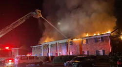 Firefighters use an aerial tower to control fire in an Augusta apartment building on Dec. 8, 2021.