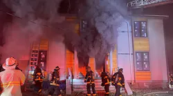 Heavy smoke pushes out the front of a multiple story occupancy in Boston on Dec. 3, 2021.