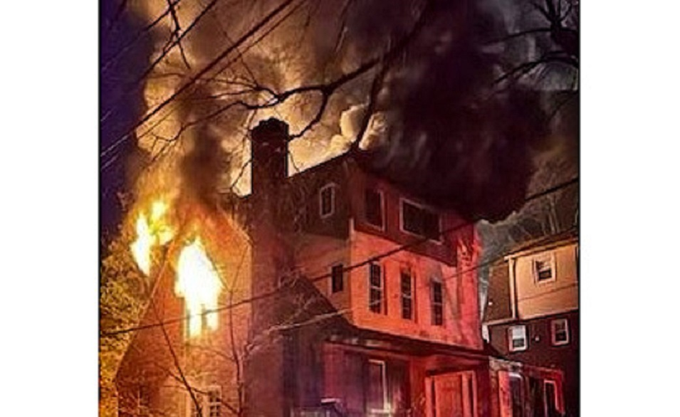 Fire breaks through the upper floors of a D.C. home Tuesday evening.