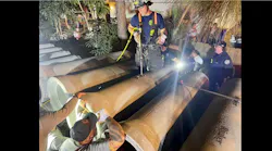 Fire crews prepare to use a chisel to free a trapped child from a concrete pipe.