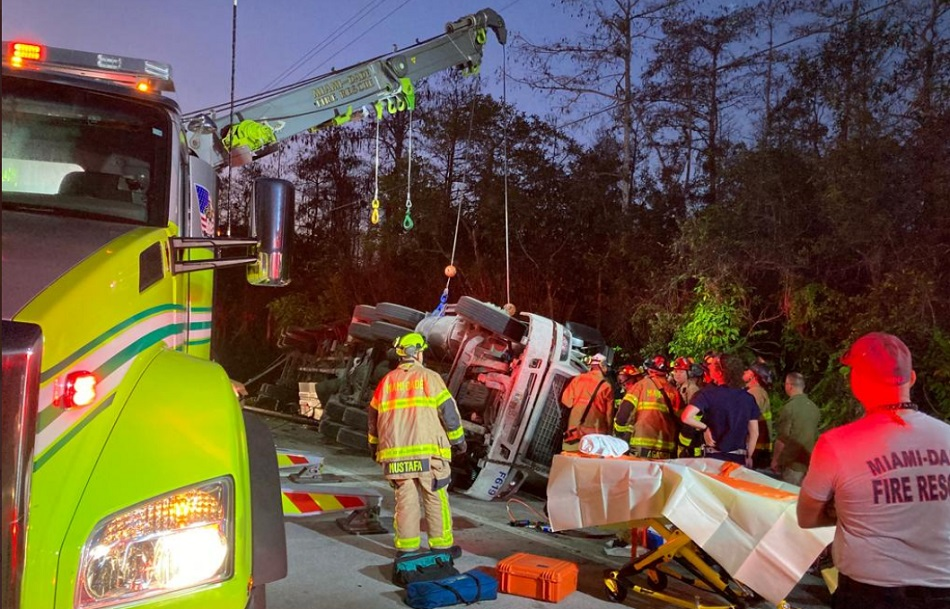 Fire crews work to extricate a heavily trapped cement truck driver.
